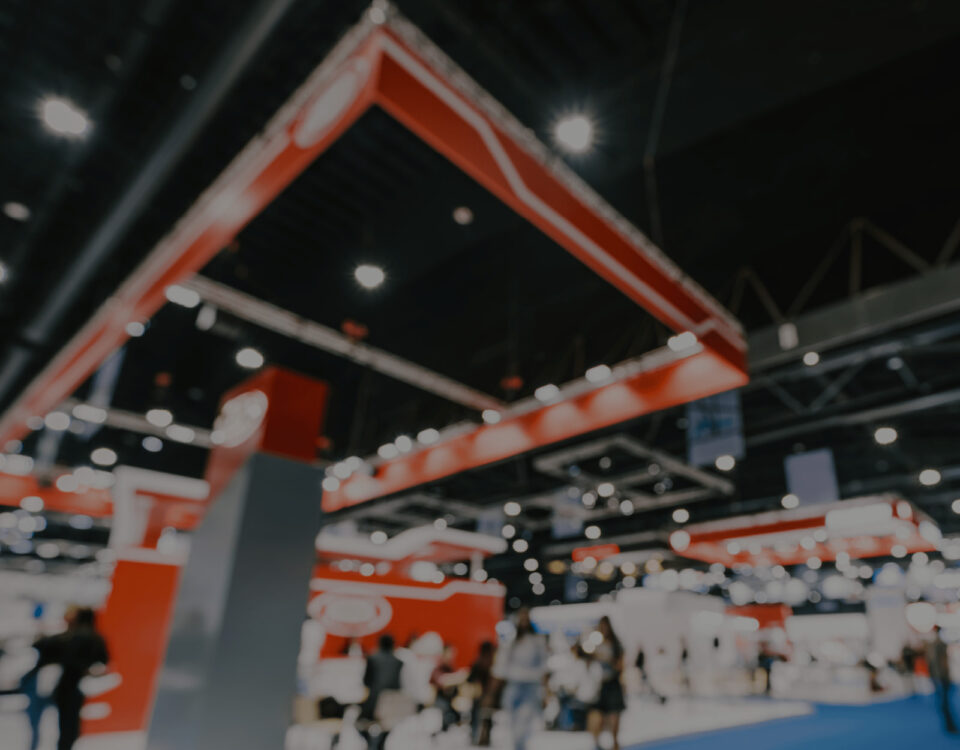 blurred convention banner red booth ceiling rafters