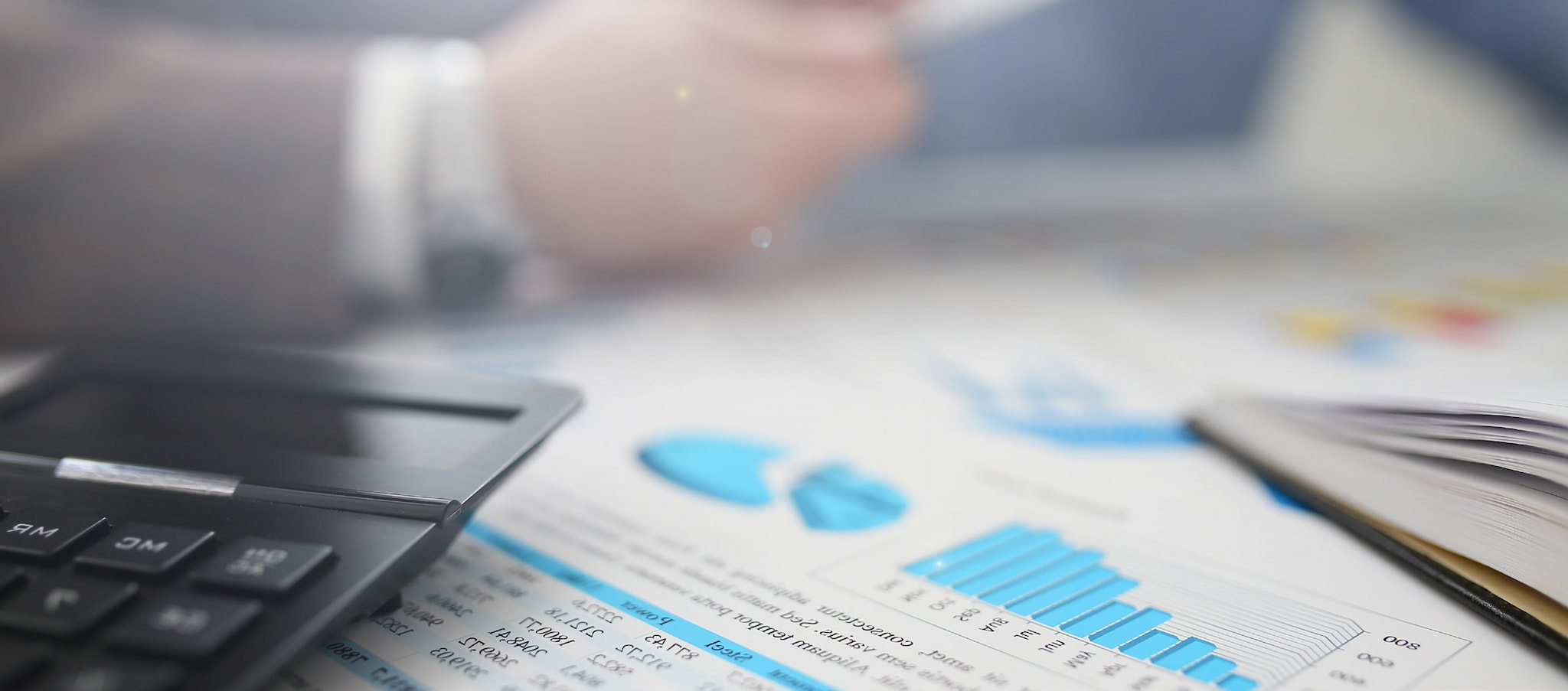 financial calculator graphs charts on office desktop