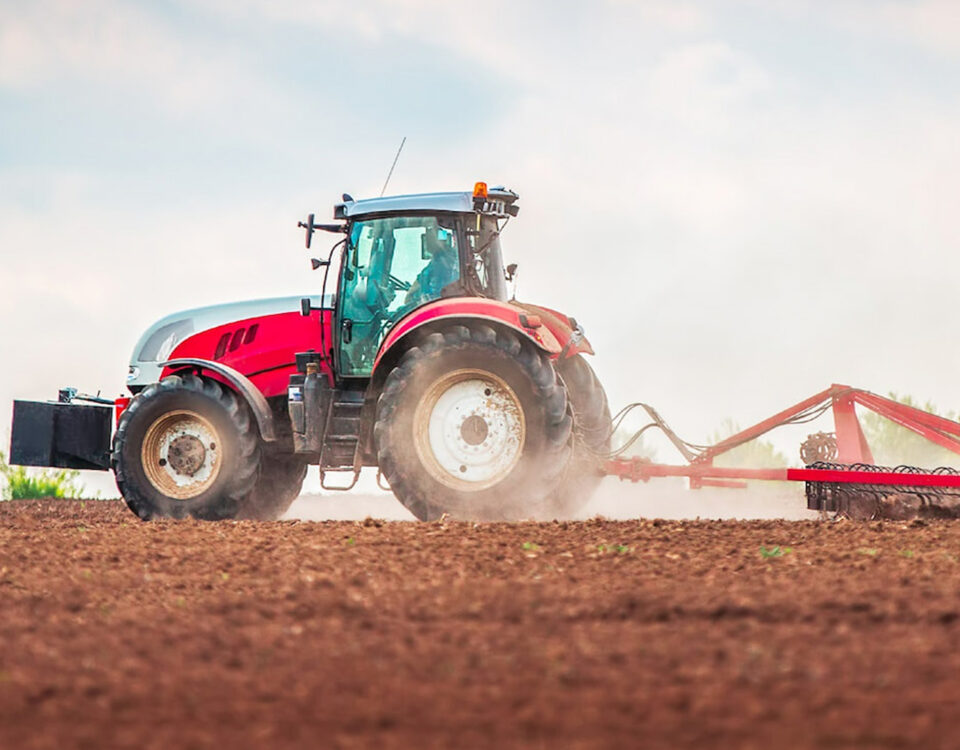 red tractor ploughing field