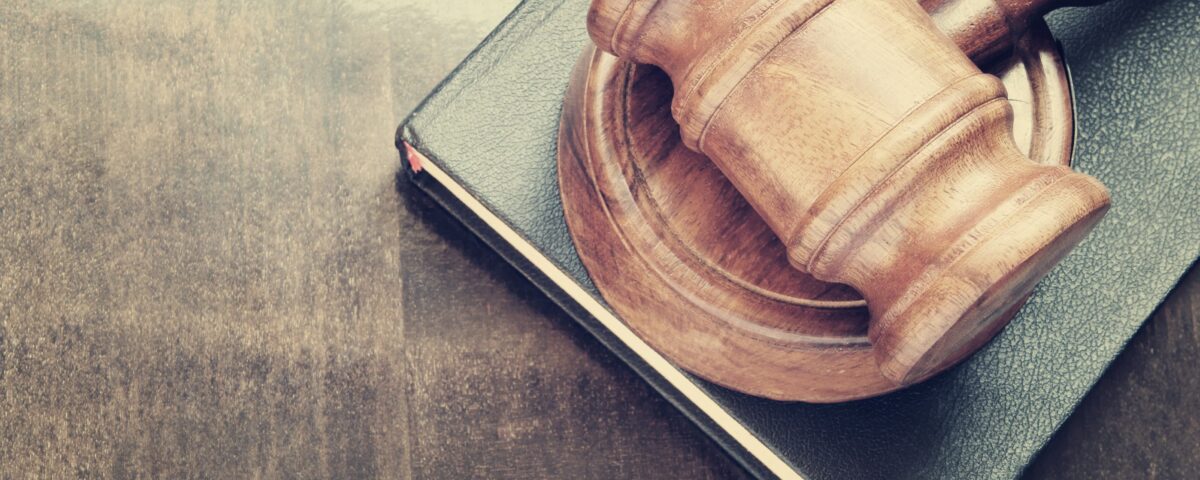 judge gavel on leather book wood desk