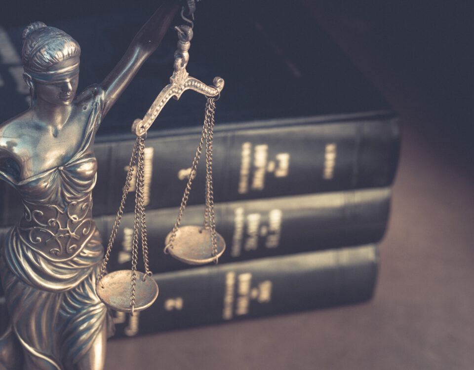 Justice scale statue in law office with law books