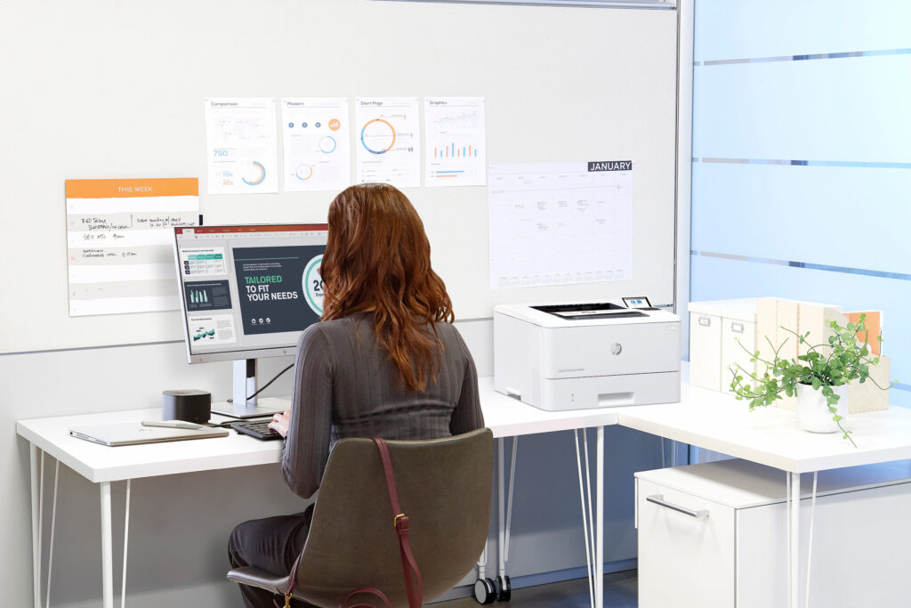 woman in white office designing marketing documents hp office printer