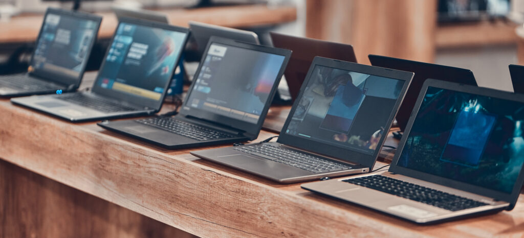 HP laptops arranged on wood table