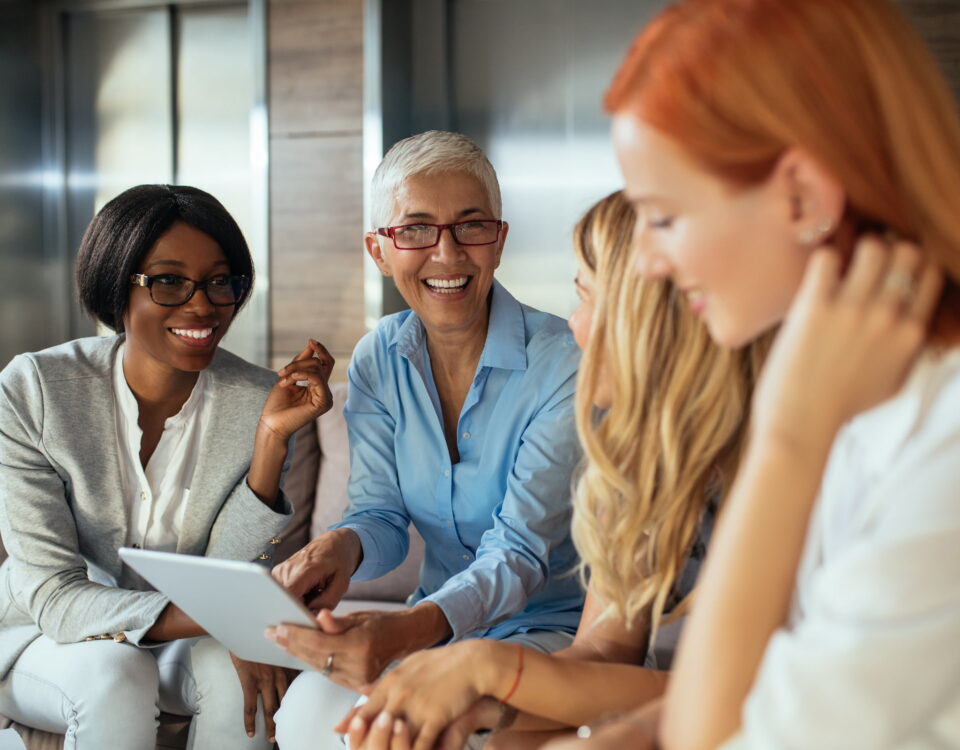 four diverse women workplace elevators lobby