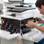 man fixing office printer repair service