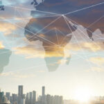 man looking at city skyline at dusk global overlay