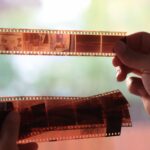 anaolog-photography-on-filmstrip-hands-holding-microfilm