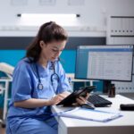nurse on tablet at computerdesk square