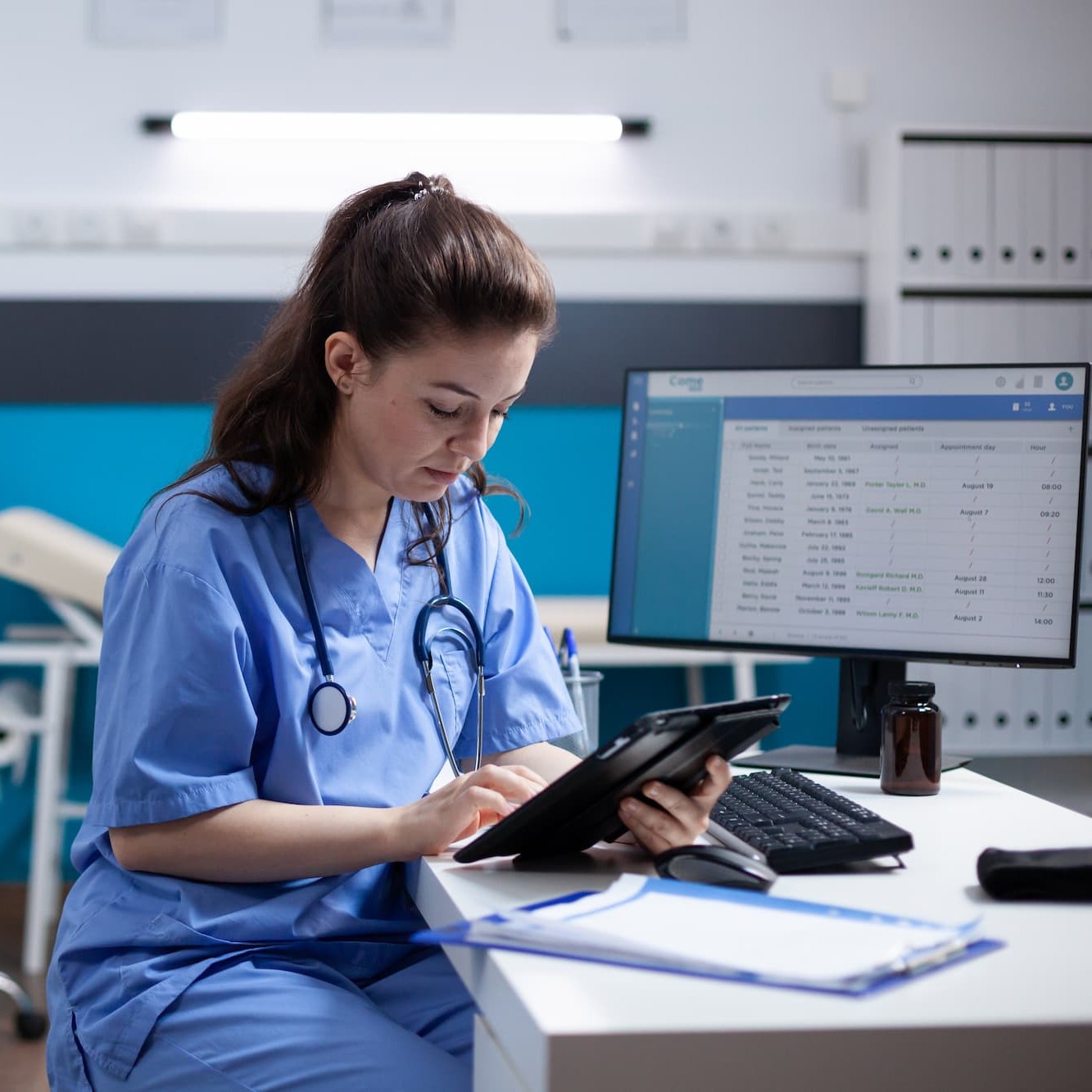 nurse on tablet at computerdesk square